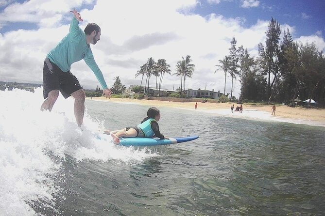 Group Surf Lessons for beginners on the North Shore of Oahu - Catching your first wave with Connor’s help