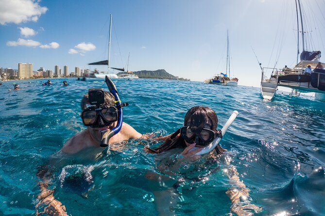 Moana’s Waikīkī Grand Guided Turtle Snorkel & Sailing Adventure - Sailing home with Diamond Head and a drink